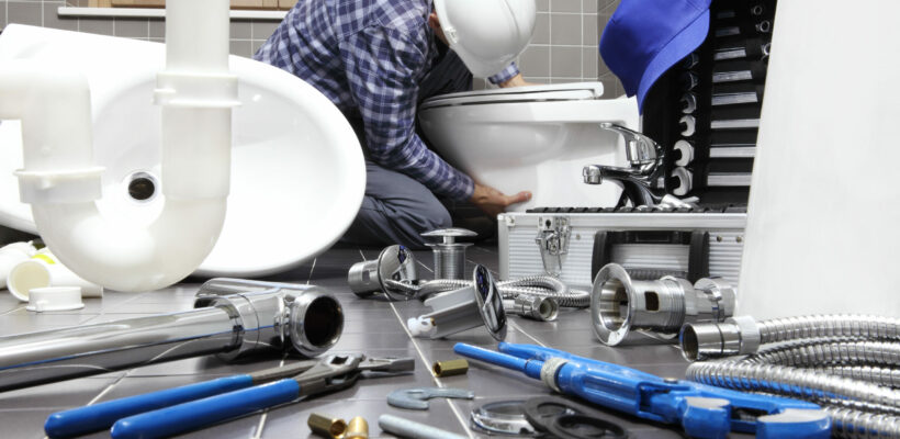 plumber at work in a bathroom, plumbing repair service, assemble and install concept